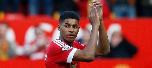 Marcus Rashford applauds their fans after the match