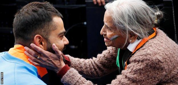 India captain Virat Kohli meets supporter Charu Latta Patel at the end of the match