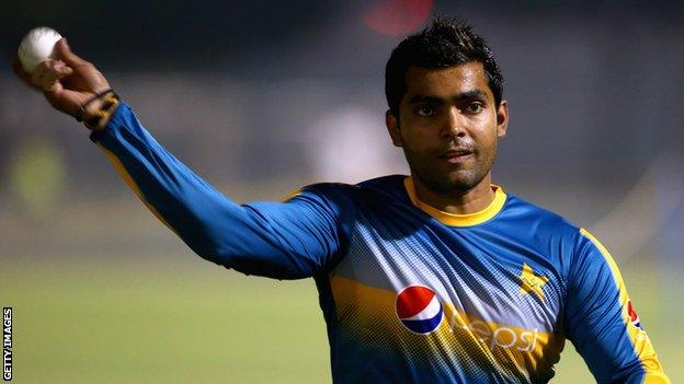 Pakistan batsman Umar Akmal throws a ball in training