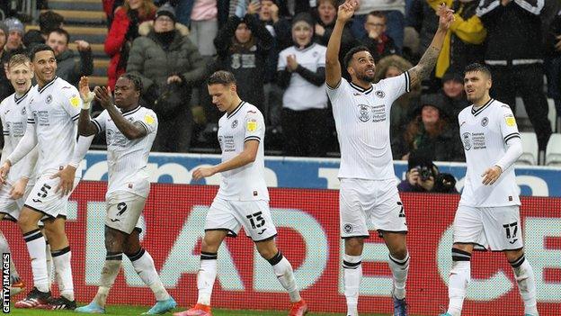 Cyrus Christie points to the sky in tribute to his grandmother