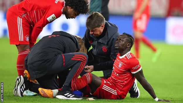 Sadio Mane reacts after suffering an injury while playing for Bayern Munich