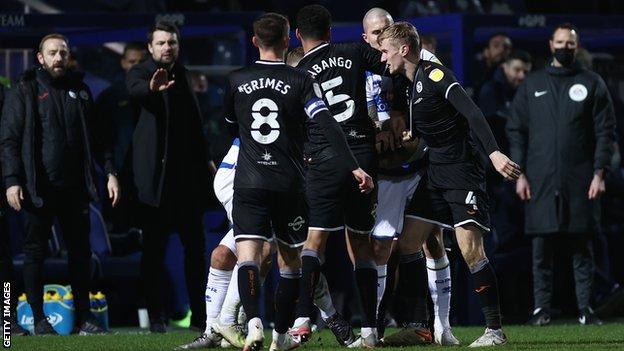 Russell Martin watches the clash which led to Flynn Downes' sending off a QPR