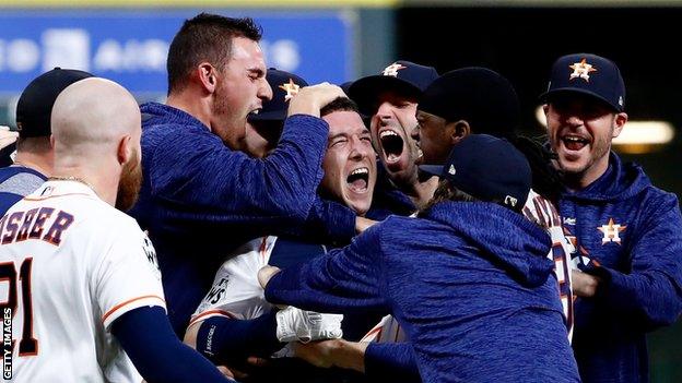 Alex Bregman is mobbed by team-mates after giving the Astros victory