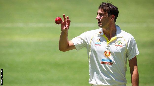 Australia Test captain Pat Cummins catches the ball during a bowl spell in the first Ashes Test against England at the Gabba