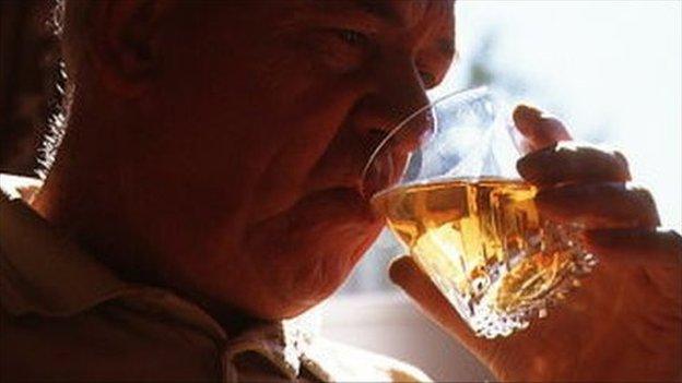 Elderly man drinking