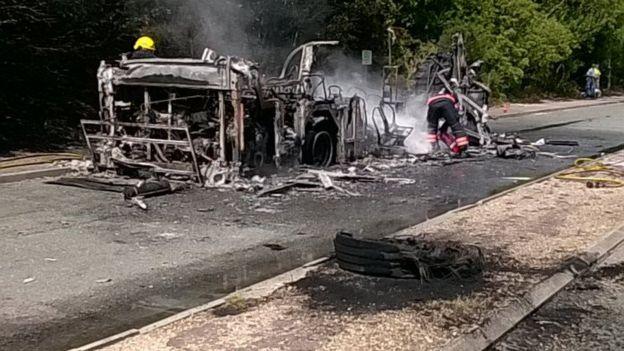 The wreckage of the burnt out bus by the side of the A11