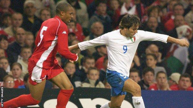 Danny Gabbidon (left) challenges Italy forward Vincenzo Montella