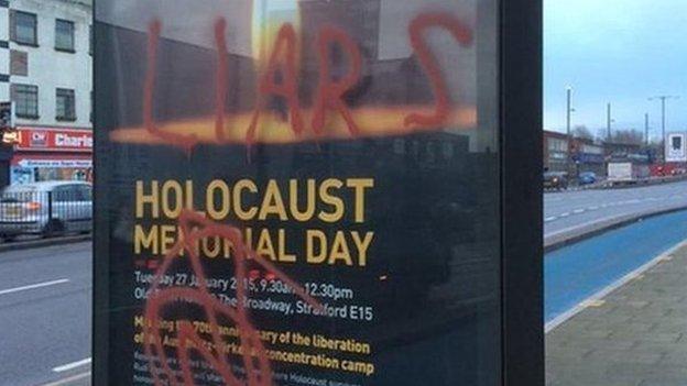 Poster advertising a Holocaust memorial event in east London daubed with graffiti including the words "liars" and "killer"