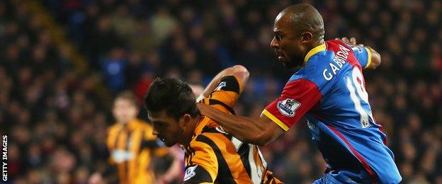 Danny Gabbidon challenges Shane Long (left)