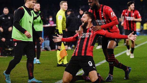 Olivier Giroud celebrates scoring for AC Milan at Napoli