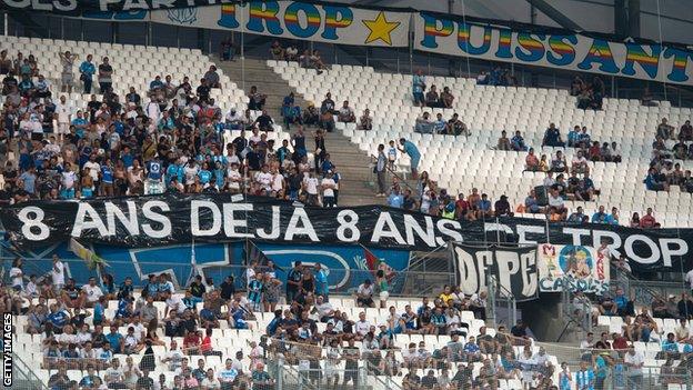 Marseille fans hold up protest banners.