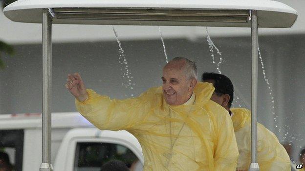 Pope Francis waves to the faithful as he arrives in Tacloban