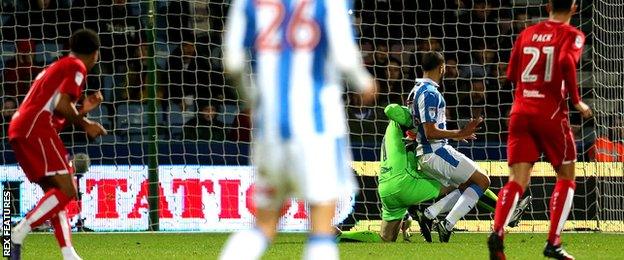 Nahki Wells of Huddersfield Town steals the ball off Frank Fielding of Bristol City to score his sides second goal