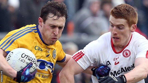 Conor Devaney of Roscommon on possession against Peter Harte of Tyrone