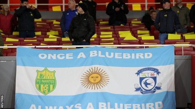 Cardiff fans unveil Argentina flag with Cardiff and Nantes badges on in tribute to Emiliano Sala.