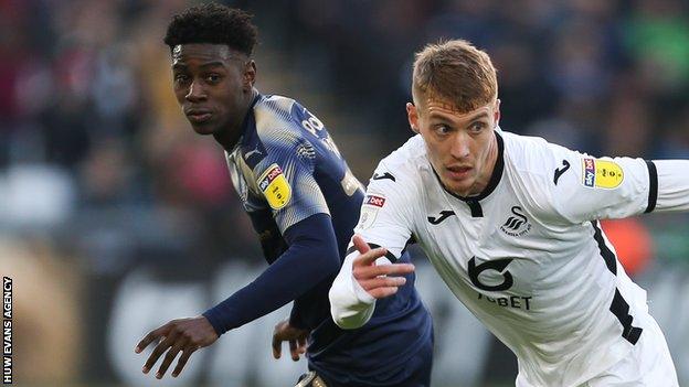 Jay Fulton of Swansea City gets away from Clarke Oduor of Barnsley