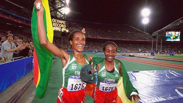 Derartu Tulu (left) celebrates breaking an Olympic Record after winning the women's 10,000m at the 2000 Olympic Games in Sydney.