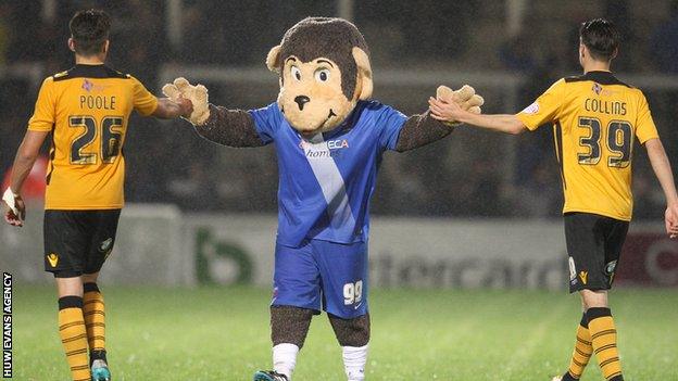 Newport pair Regan Poole and Aaron Collins get a welcome from Hartlepool mascot H'Angus the Monkey during County's recent defeat