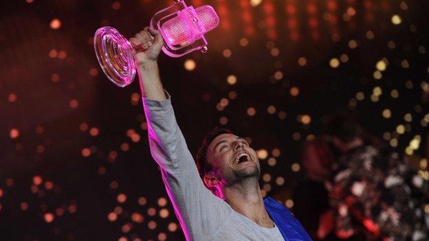 Sweden"s Mans Zelmerlow holds the trophy after winning the Eurovision Song Contest final