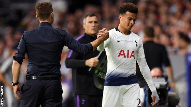 Mauricio Pochettino shakes hands with Dele Alli as he walks off after being substituted during the UEFA Champions League Final