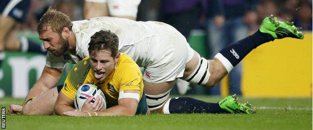 Bernard Foley scores for Australia despite the attentions of England captain Chris Robshaw