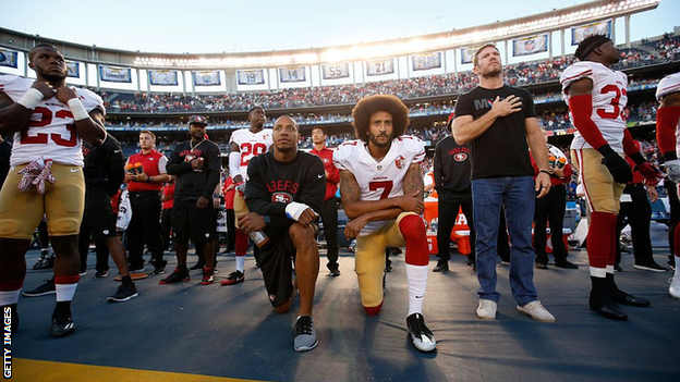 Colin Kaepernick kneels during the national anthem