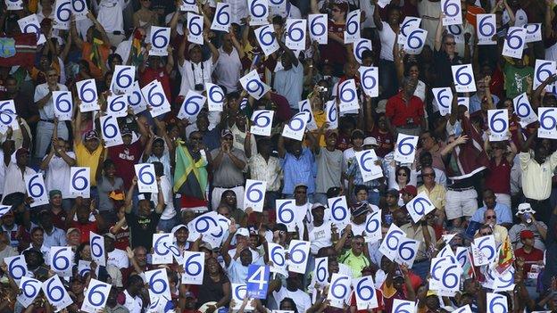 Crowd with six signs