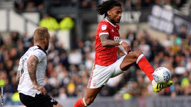 Armand Traore stretches for the ball