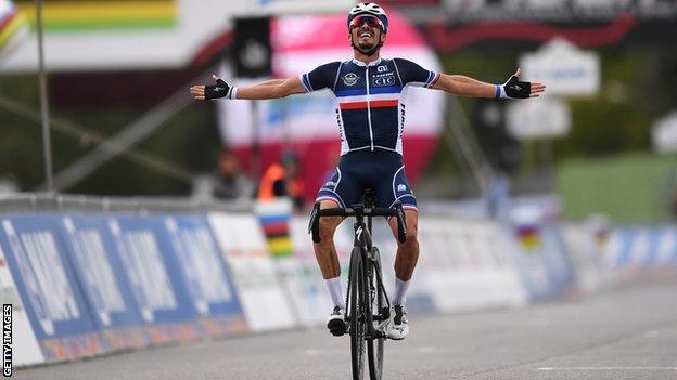 Julian Alaphilippe celebrates as he crosses the line