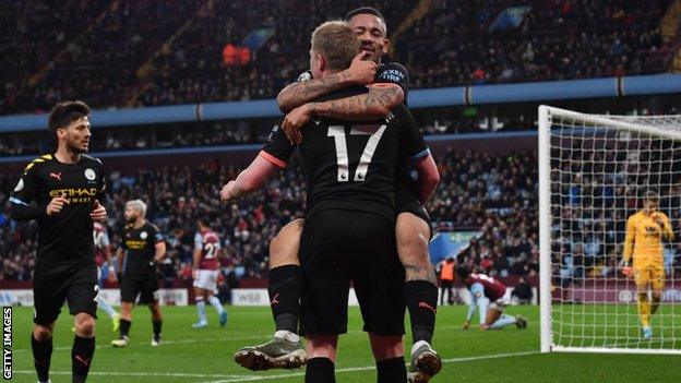 Manchester City's players celebrate scoring at Aston Villa