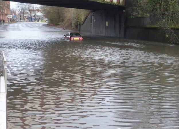 A car is submerged in water on Haggs Road, Glasgow