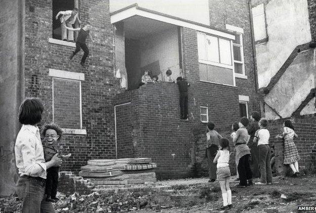 Photograph of children playing in disused building