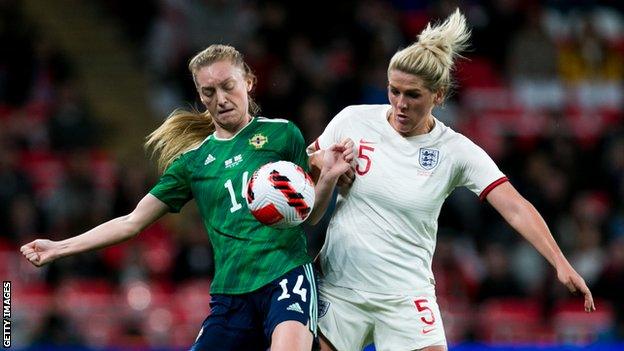 Lauren Wade of Northern Ireland (left) and Millie Bright of England (right)