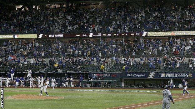 LA Dodgers fans celebrate the moment their side clinch victory in the World Series