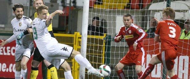 Johnny Addis fires Glentoran into a 12th minute lead at windswept Solitude on Wednesday night