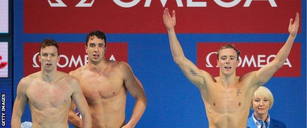 Daniel Wallace, Calum Jarvis and Robert Renwick of Great Britain react after winning the gold medal in the Men's 4x200m freestyle relay in Kazan