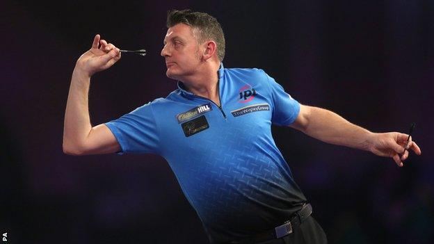 Justin Pipe throws a dart during victory over Bernie Smith at the PDC World Championship