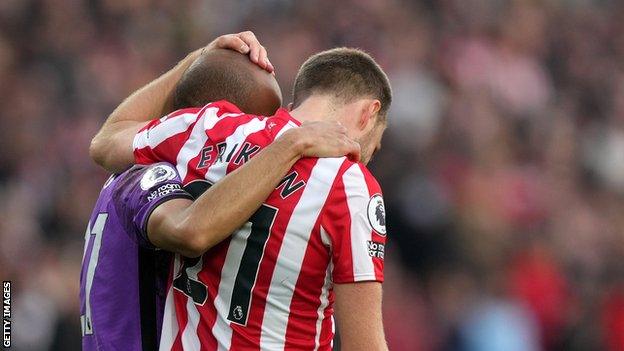 Christian Eriksen hugging Lucas Moura