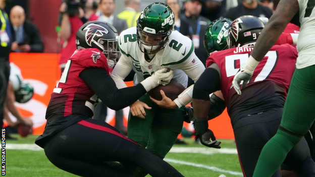 Zach Wilson is tackled by Adetokunbo Ogundeji and Grady Jarrett