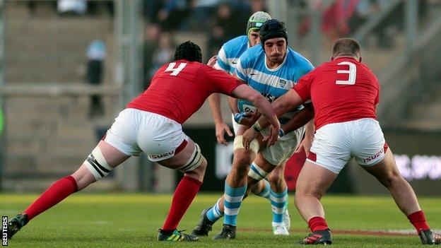 Argentina's Tomas Lavanini is stopped by Wales" Adam Beard (4) and Dillon Lewis