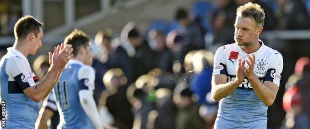 Rangers defender Clint Hill applauds the visiting fans at full-time