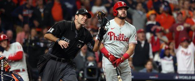 Philadelphia Phillies outfielder Kyle Schwarber reacts after hitting what he thinks is a home run, but was overturned