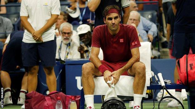 Roger Federer looks glum as he sits courtside at the US Open