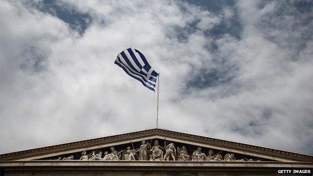 A Greek flag against a bleak sky