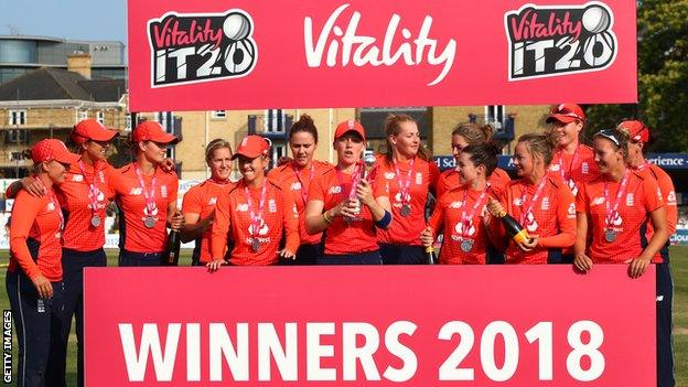 England women's cricket side celebrate with the trophy after winning the Twenty20 tri-series