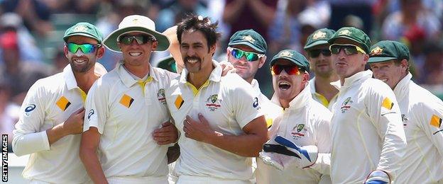 Mitchell Johnson (centre) celebrates with team-mates