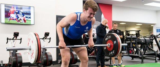 An academy rugby player lifts weight