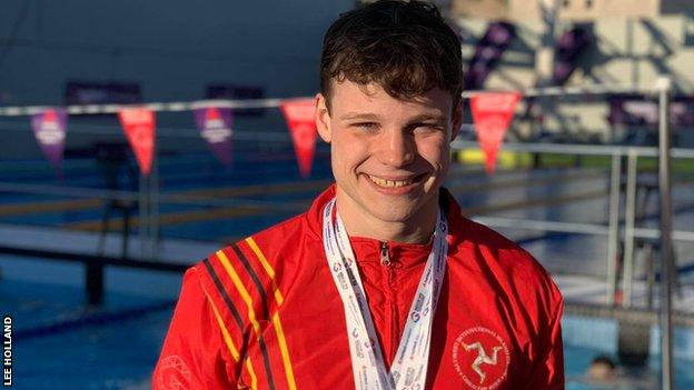 Alex Bregazzi wears some of the medals that he has won at the Island Games