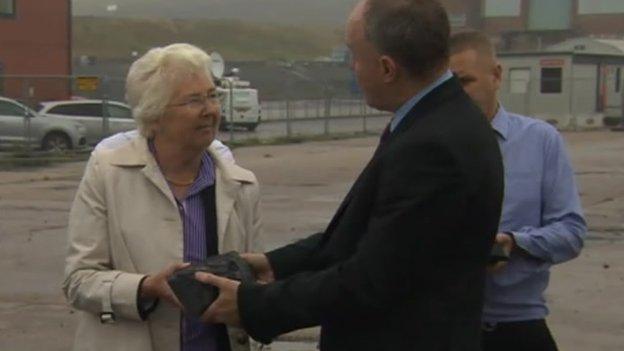 Ros Jones accepts lump of coal from John Grogan