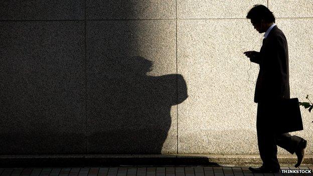 Man walking along in shadow